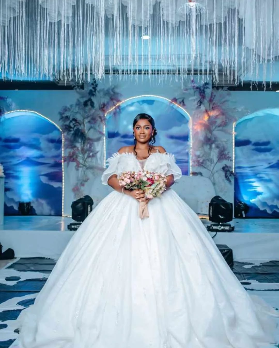 Bride on a blue-lit ceremony stage
